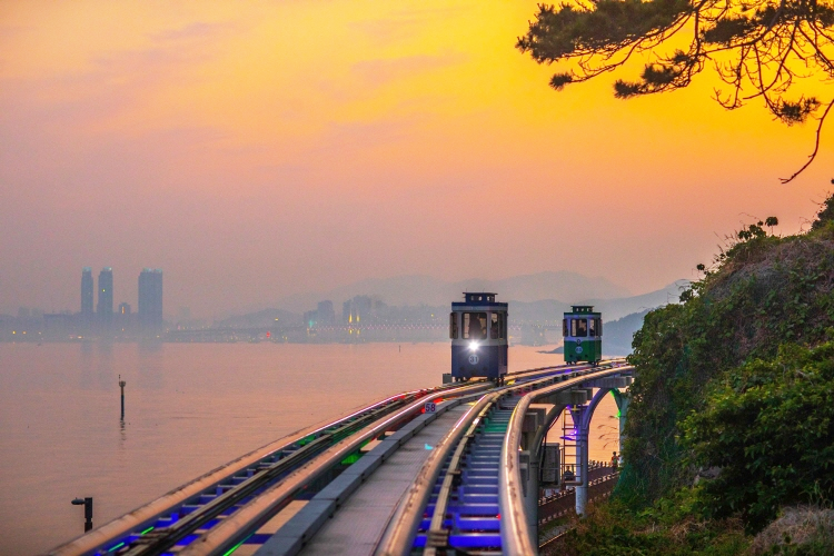 Official image of the Busan Sky Capsule Tour at sunset