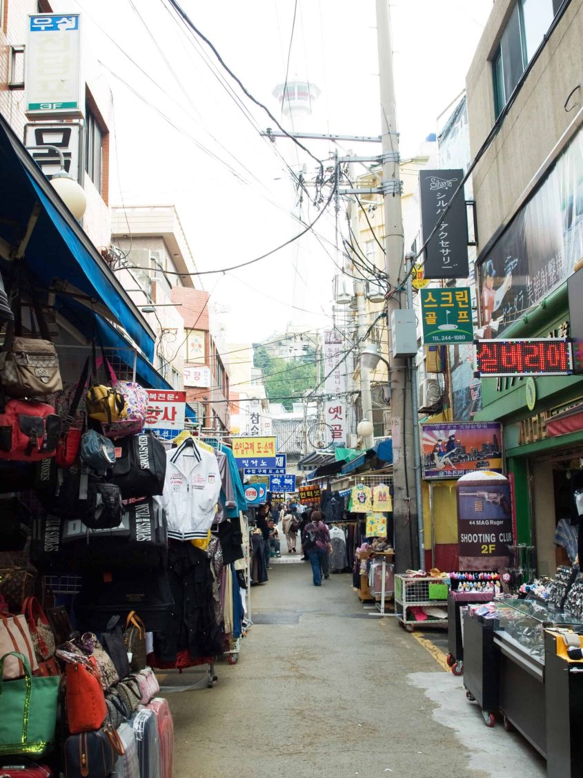 Vibrant Korea street market with shops and shoppers.