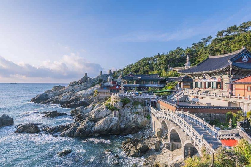 Seaside temple in Busan, Korea with ocean view and traditional architecture.