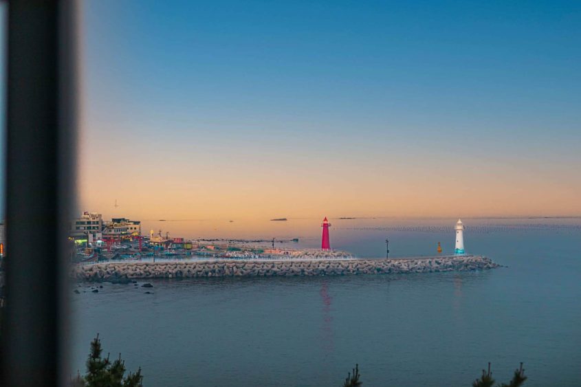 Lighthouses along the coast of Busan, Korea, during sunset, perfect for Korea travel experiences.